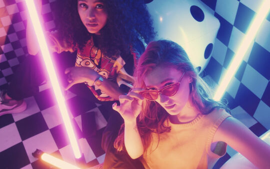 Urban Girls Between Bars Of Colored Light 540x337